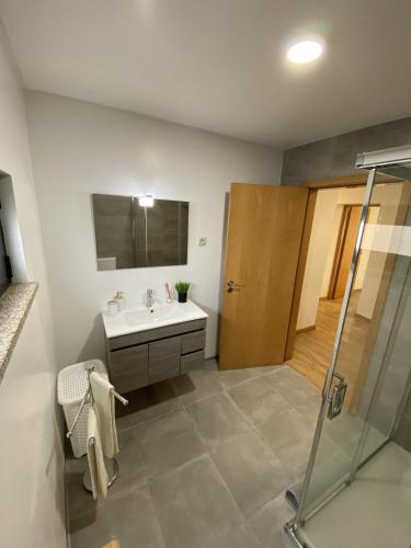 a bathroom with a sink and a shower at Casa Rodrigues in Terras de Bouro
