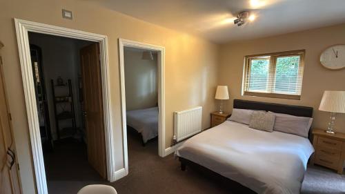 a bedroom with a bed and a mirror at Kendall Lodge in Burwell