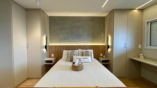 a bedroom with a bed with a basket on it at Studio Red 12 - Sorocaba in Sorocaba