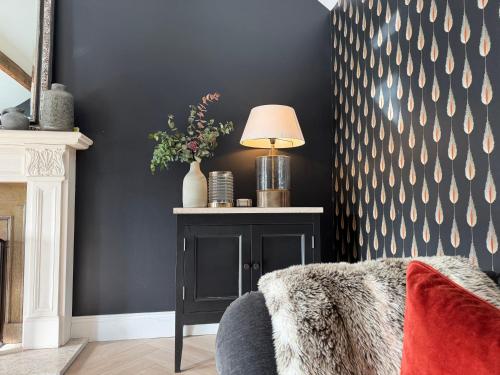 a living room with a couch and a table with a lamp at Luxury Croft Templepatrick Near Airport Rabbit and Hilton hotel in Templepatrick