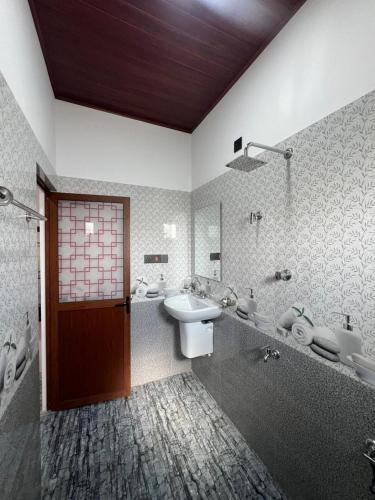 a bathroom with a sink and a shower at Apollo Villa Weligama in Weligama