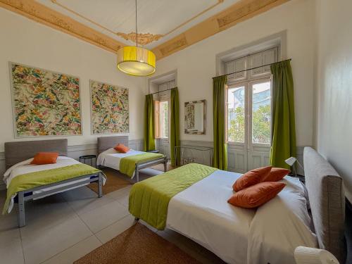 a bedroom with two beds and a window at Happy House Hostel in Santiago