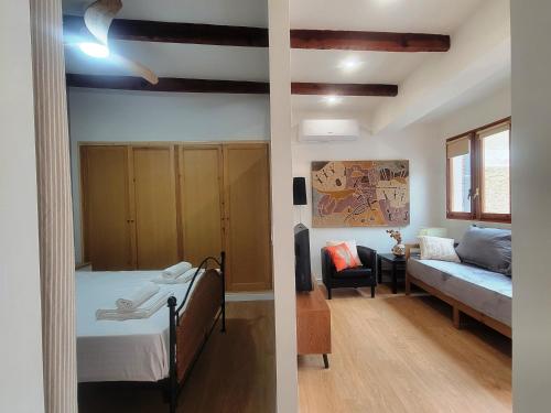 a bedroom with a bed and a living room at Casa ALFANG in Torrent