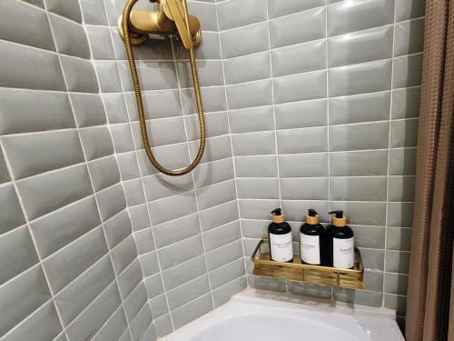 a bathroom with three bottles on a shelf above a sink at Casa ALFANG in Torrent