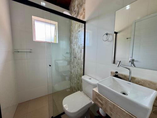 a bathroom with a sink and a toilet and a shower at Chalés São Pedro in Socorro
