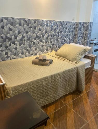 a bedroom with a bed with two slippers on it at Microcasas in Nova Friburgo