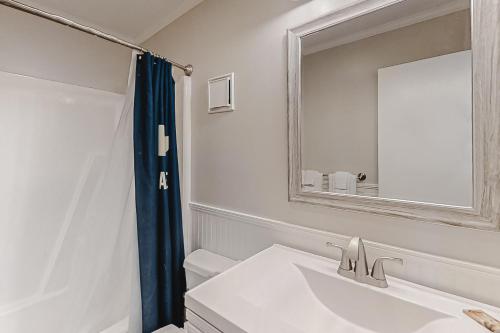 a white bathroom with a sink and a mirror at ABDV22 Dunescape Villas 236 in Atlantic Beach