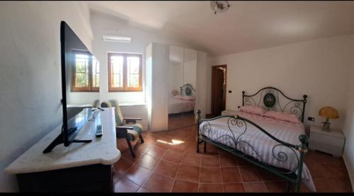 a bedroom with a bed and a dresser and a desk at VILLA CATERINA in Calasetta