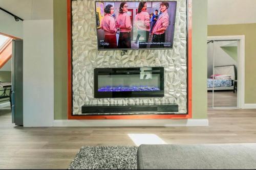 a fireplace in a living room with a tv on a wall at LARGE STUDIO open concept in Boston Zoo Franklin Park near in Boston