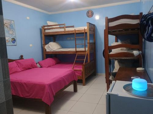 a room with two bunk beds and a bed at Hostel e pousada paz e benção in Mossoró