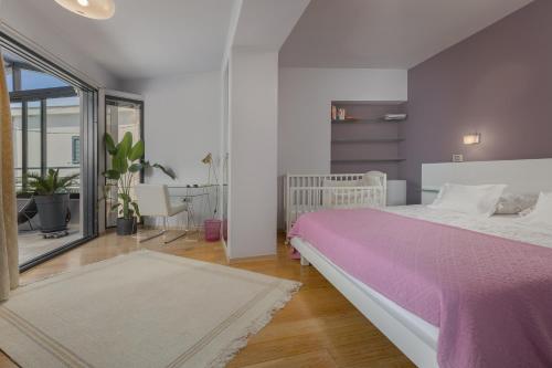 a bedroom with a large bed with a pink blanket at Apartments Glusac in Podgora