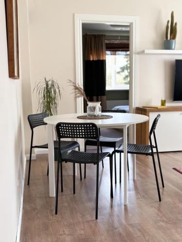 a white table and chairs in a room at Sigulda center apartments in Sigulda