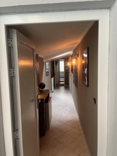 a hallway with a door leading to a hallway with a hallway at Eporedia Inn in Ivrea