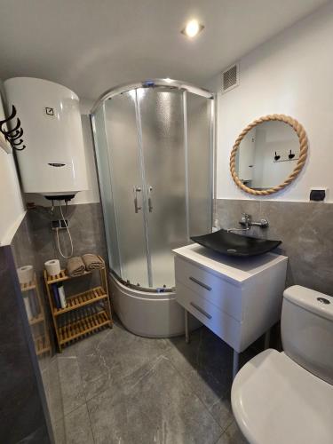 a bathroom with a shower and a sink and a toilet at Apatrament Jagielońska in Legnica