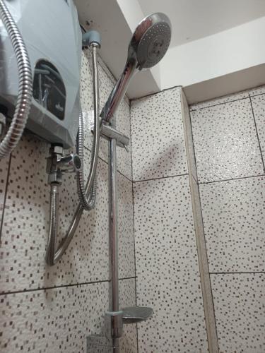 a shower head on a wall in a bathroom at Amazing views PISAQ in Pisac
