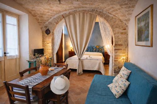 a living room with a bed and a blue couch at La Masseria in Vasto