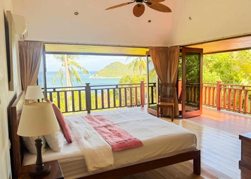 a bedroom with a bed with a view of the ocean at Villa Vadee - Entire Private Villa, 4 Bedrooms, Large Swimming Pool, Ocean View in Thong Nai Pan Noi