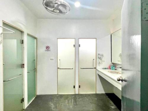 a bathroom with white walls and doors and a sink at Luxus Grand Hotel in Patong Beach