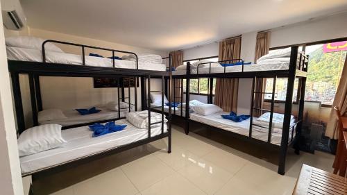 a room with four bunk beds in a room at Luxus Grand Hotel in Patong Beach