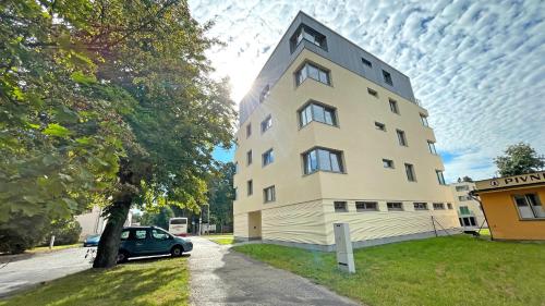 a building with a car parked in front of it at PORTA Apartment in Františkovy Lázně