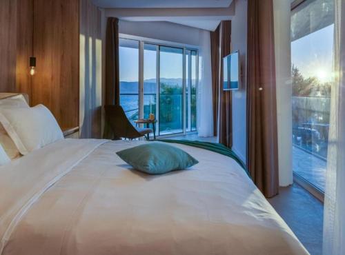 a bedroom with a large bed with a pillow on it at Villa La Bella Vista in Basina
