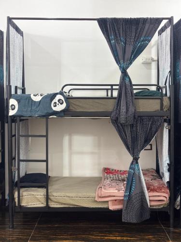 a couple of bunk beds in a room at Manavi Home Stay in Mathura