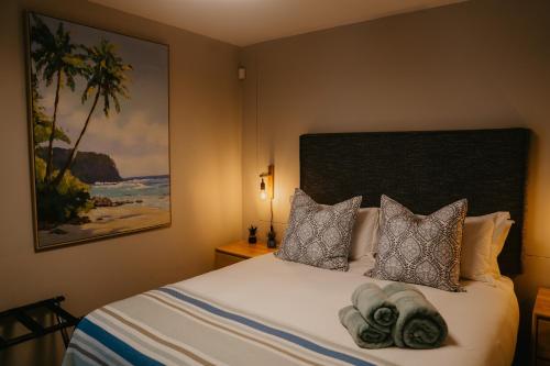 a bedroom with a bed with towels on it at Seaside tranquility in Gonubie in East London