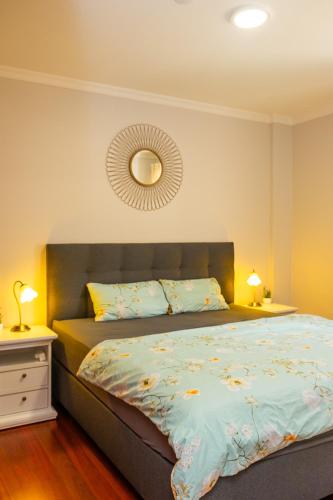 a bedroom with a bed and a mirror on the wall at StayinMachico in Machico