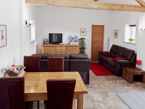 a living room with a table and a couch at The Byre in Great Ayton