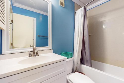 a bathroom with a sink and a mirror at ABPAB167 Blue Haven Beach Retreat in Atlantic Beach