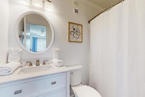 a white bathroom with a sink and a mirror at ABPAB166 Sandy Shores in Atlantic Beach