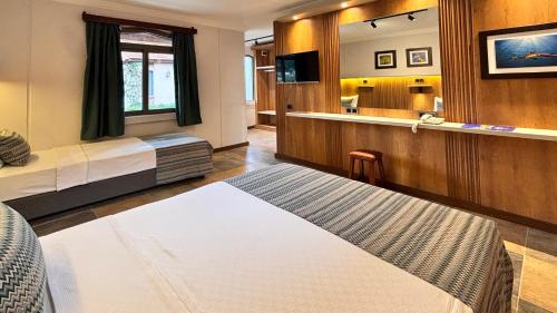 a hotel room with two beds and a mirror at Denizati Holiday Village in Gumuldur