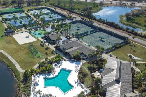an aerial view of the pool and tennis court at the resort at Stunning Sunset Scenes in Wesley Chapel