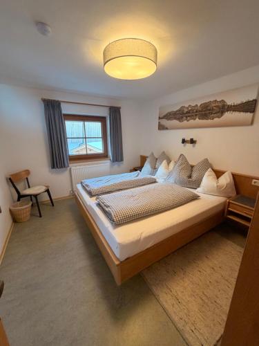 a large bedroom with two beds and a lamp at Hof Oberhaus in Kitzbühel