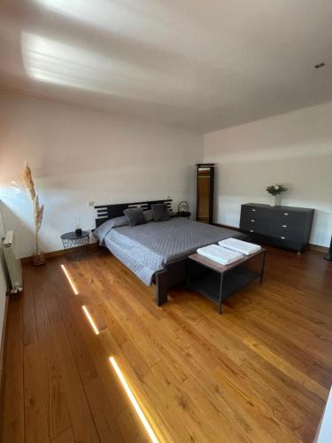 a bedroom with a bed and a wooden floor at Casa de José in Cabeceiras de Basto