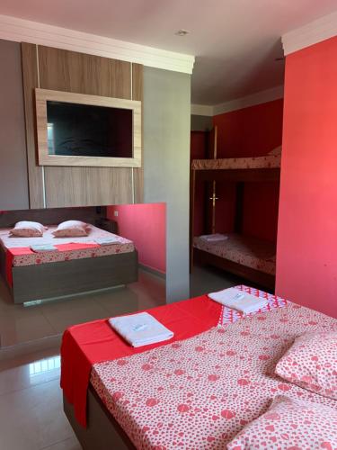 two beds in a room with two bunk beds at Hotel Lalique in São Paulo