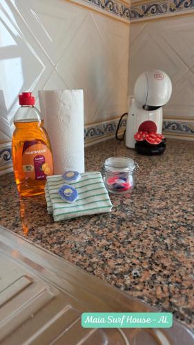 a counter with a bottle of syrup and some paper towels at Maia Surf House - Baleal in Ferrel