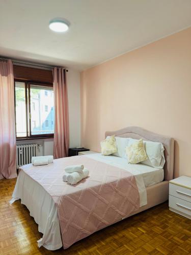 a bedroom with a large bed with two towels on it at First Dream Mestre in Mestre