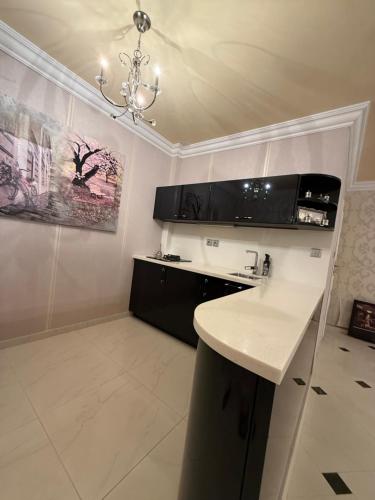 a kitchen with a white counter top and a chandelier at Lily Rose villa in Karlovy Vary