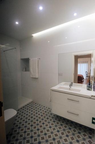 a bathroom with a sink and a toilet and a mirror at Peace In Azores in Pico da Pedra