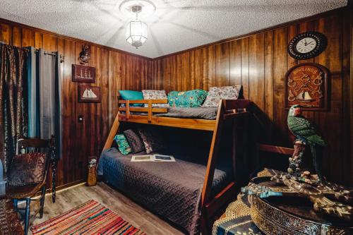 a bedroom with two bunk beds and a parrot on a shelf at ABSS102 Seaspray 224 in Atlantic Beach