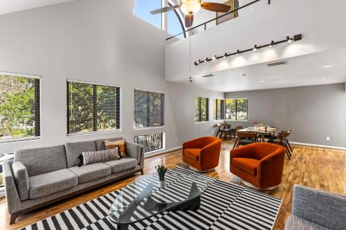 a living room with a couch and chairs and a table at Beautiful home by Medical ctr, Rice, Museums in Houston