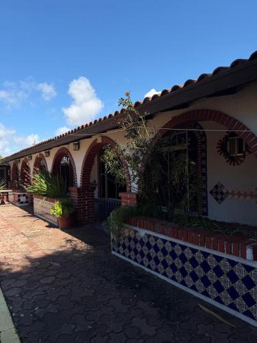 a house with an arched entryway and a brick building at Hacienda Rosarito in Rosarito Beach