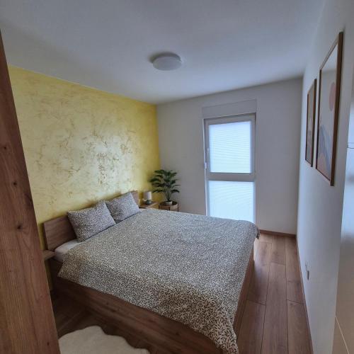 a bedroom with a bed and a window at Aura Apartment FREE PARKING in Brčko
