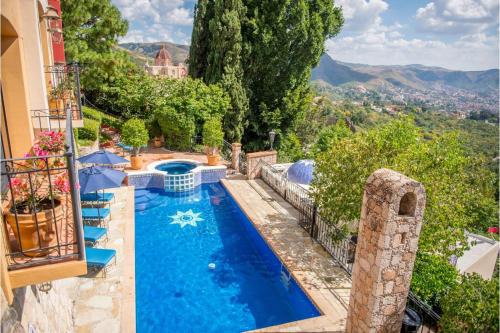 a house with a swimming pool with a view at Casa Estrella de la Valenciana Hotel Boutique in Guanajuato