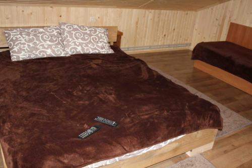a bed with two remote controls on top of it at U Bogdana in Yaremche