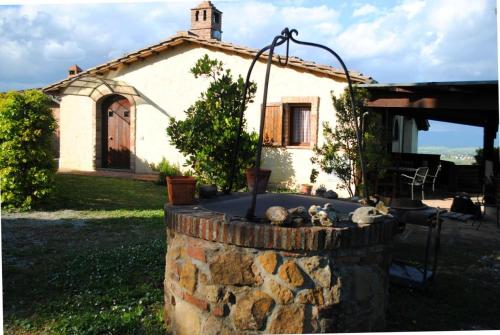 a small house with a fire pit in front of it at Corolle2 in Montepulciano
