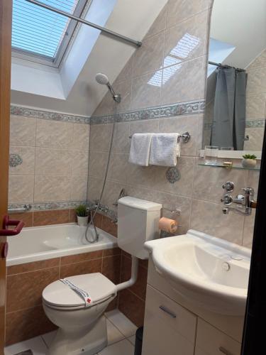 a bathroom with a toilet and a sink at Guest house Royal in Čakovec