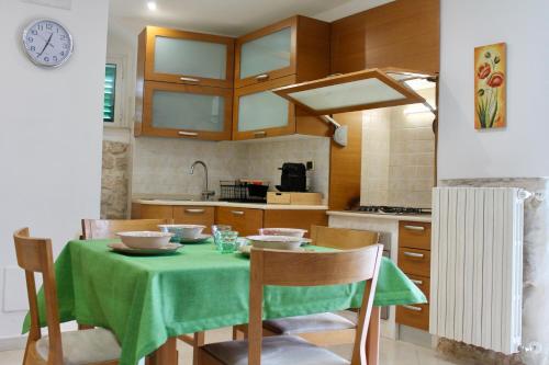 a kitchen with a table with a green table cloth at A Casa Di Giulia - Appartamento sul Lungomare - Giovinazzo in Giovinazzo