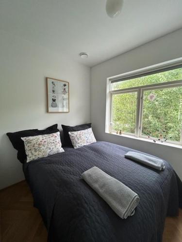 a bedroom with a large bed with a window at Seaside apartment in Volda